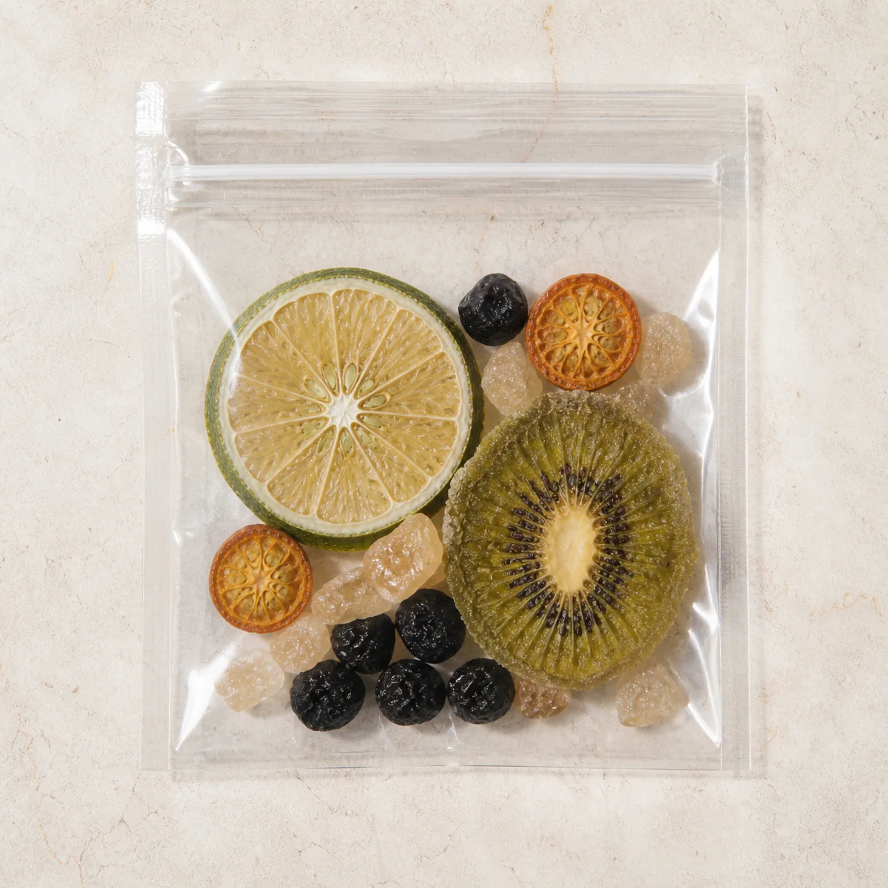 Lemon Black Currant Fruit Tea square transparent pouch showing lime, black currant, kiwi, kumquat and pale amber rock sugar