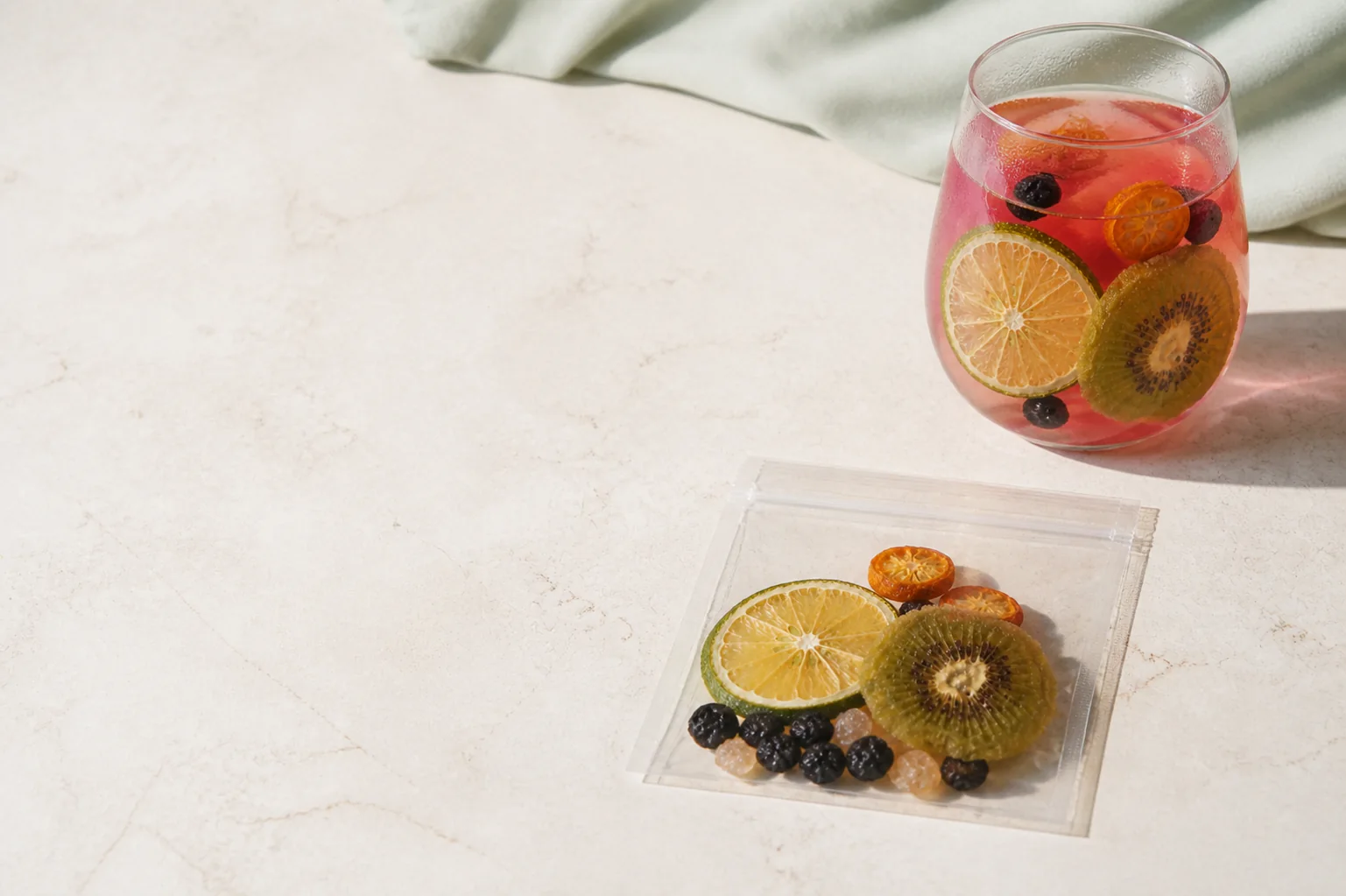 Lemon Black Currant Fruit Tea glass and transparent serving arranged with clean copy space