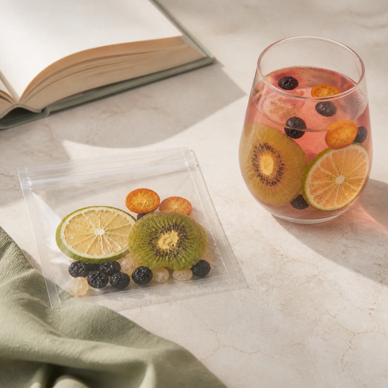 Lemon Black Currant Fruit Tea lemon black currant fruit tea glass beside an open book in warm daylight