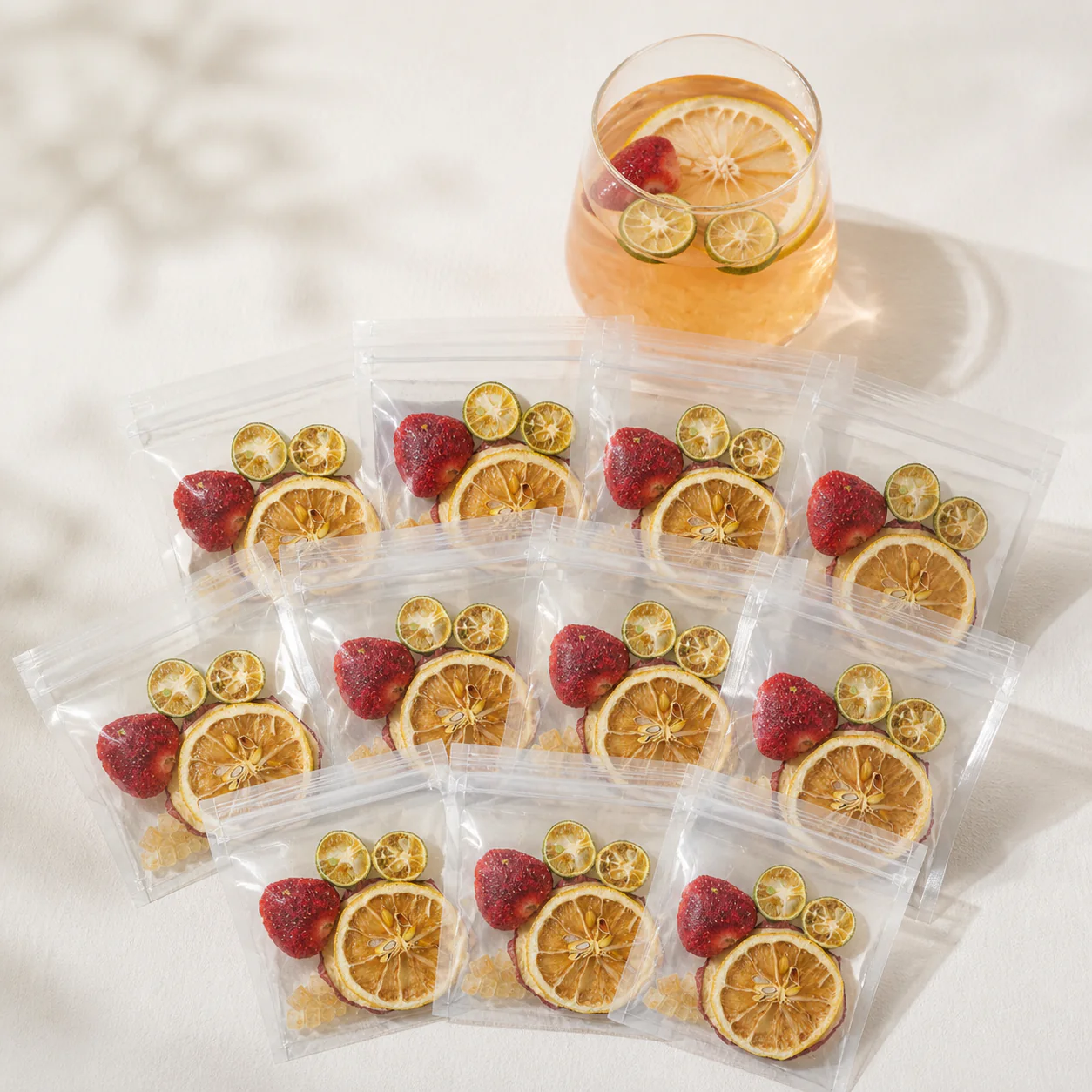 Ten individually packed strawberry apple fruit tea servings arranged for product display