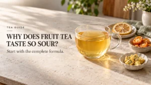 Hand holding golden fruit tea beside separate lemon, kumquat, and passion fruit ingredient example cards